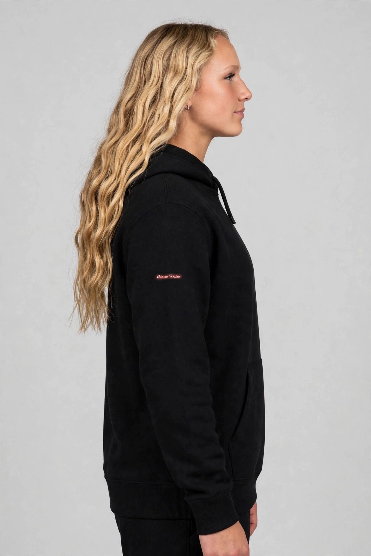Harper wearing the Hangry Harper Shakopee Hoodie – Black, left sleeve view