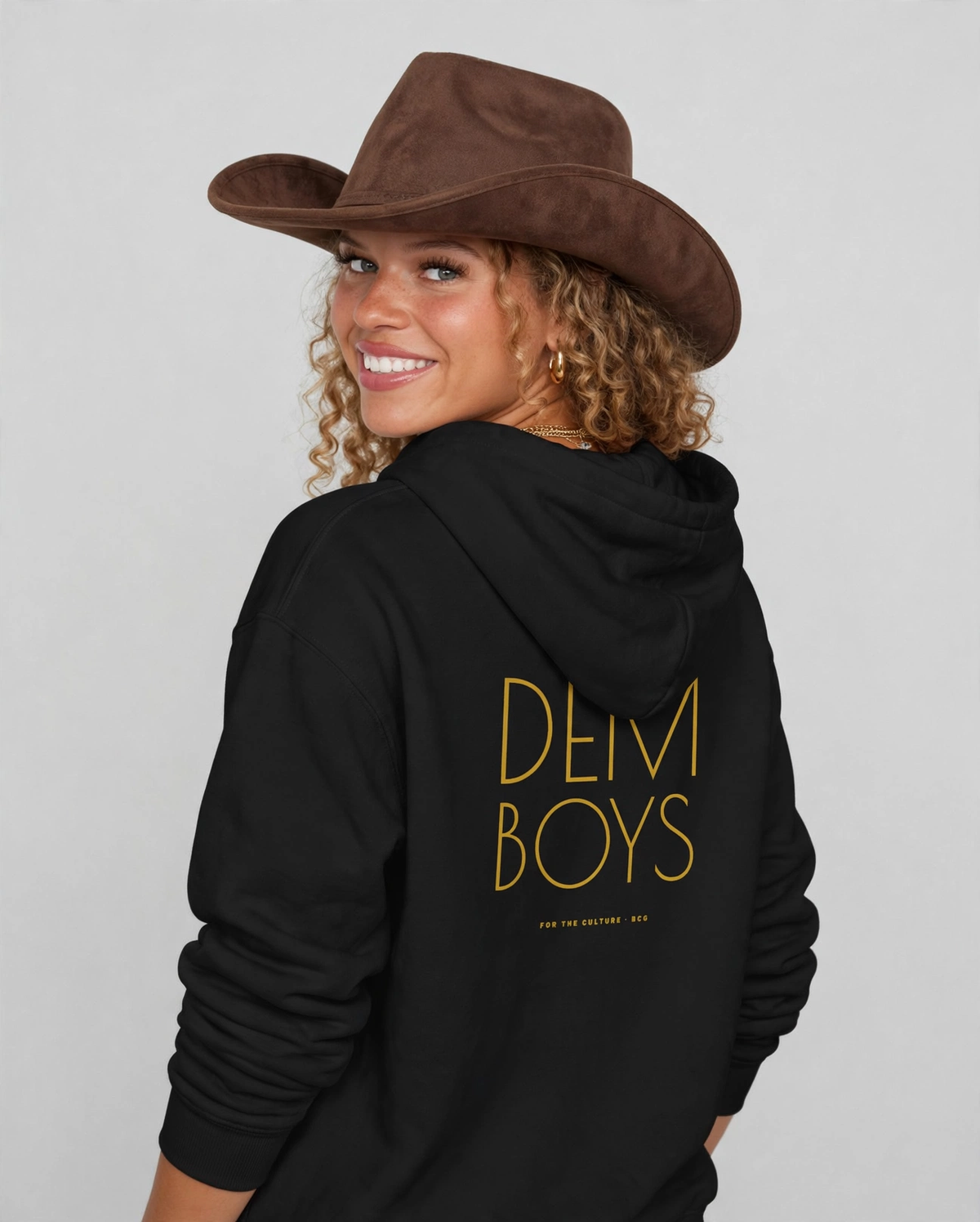 Amara wearing the DEM BOYS Hoodie – Poiret (Black), back view