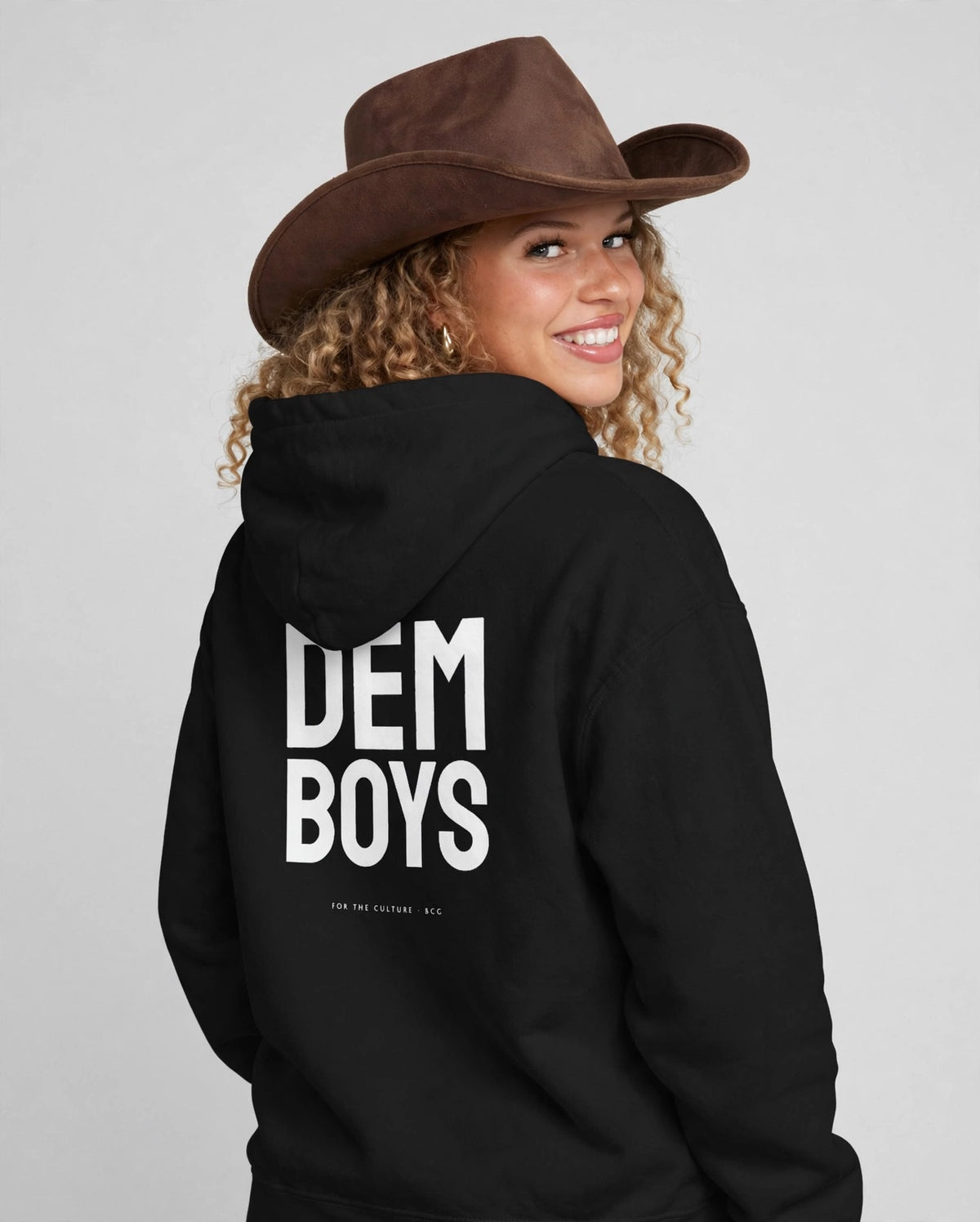 Amara wearing the DEM BOYS Hoodie – Staatliches (Black), back view