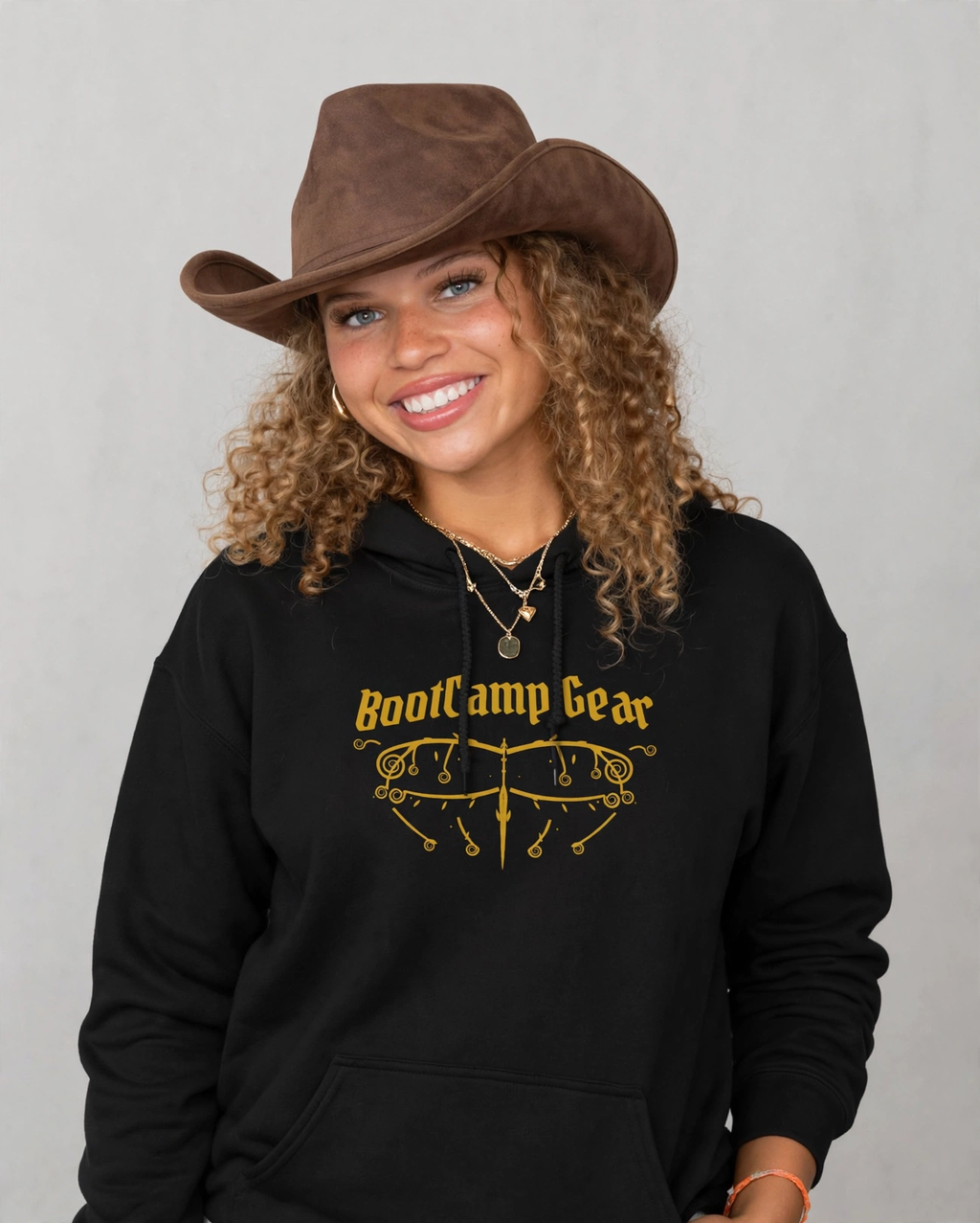 Amara wearing the BootCamp Gear Gothic Crest Hoodie - Black (Gold Crest)