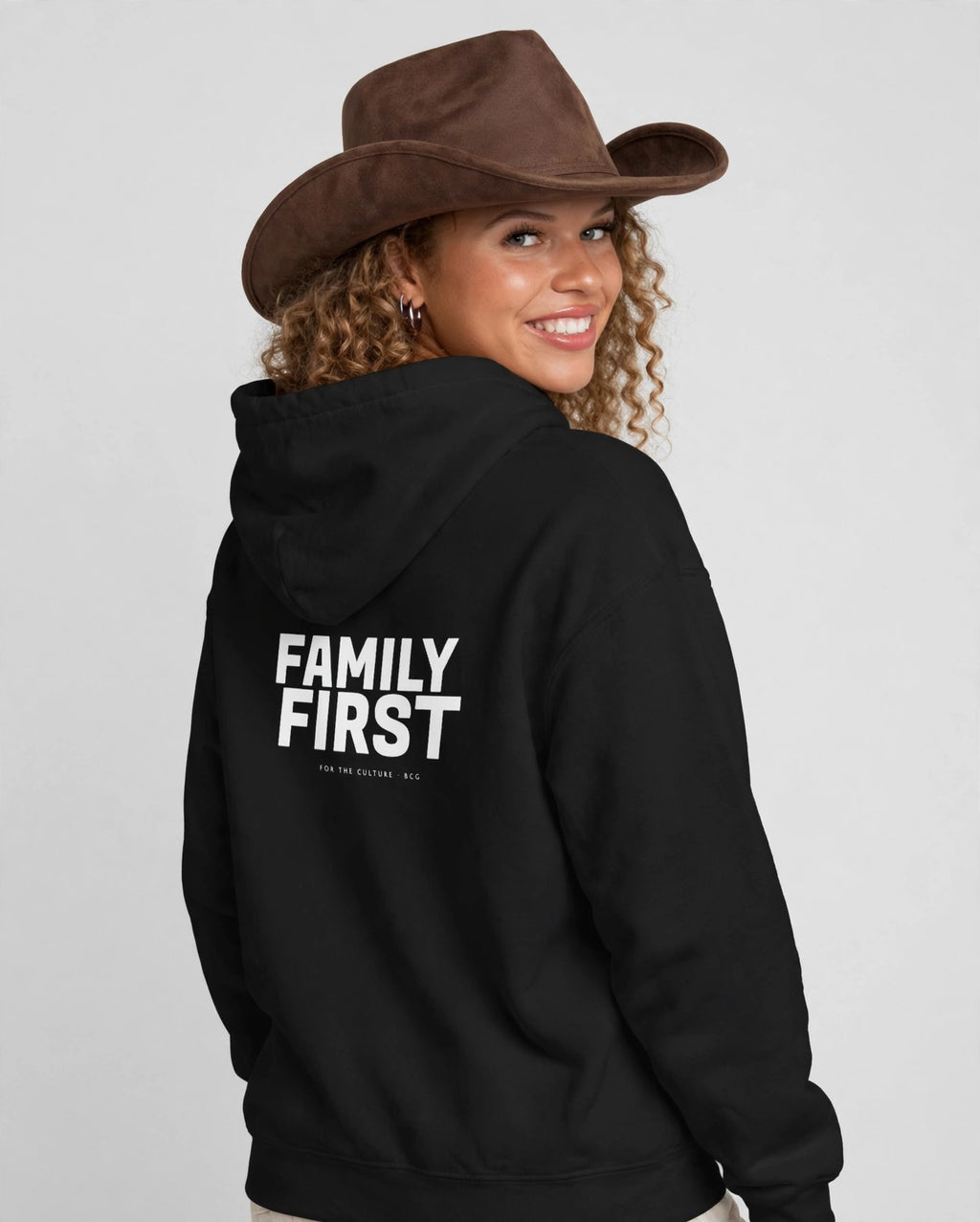 Amara wearing the Family First Hoodie – Fugaz (Black), back view