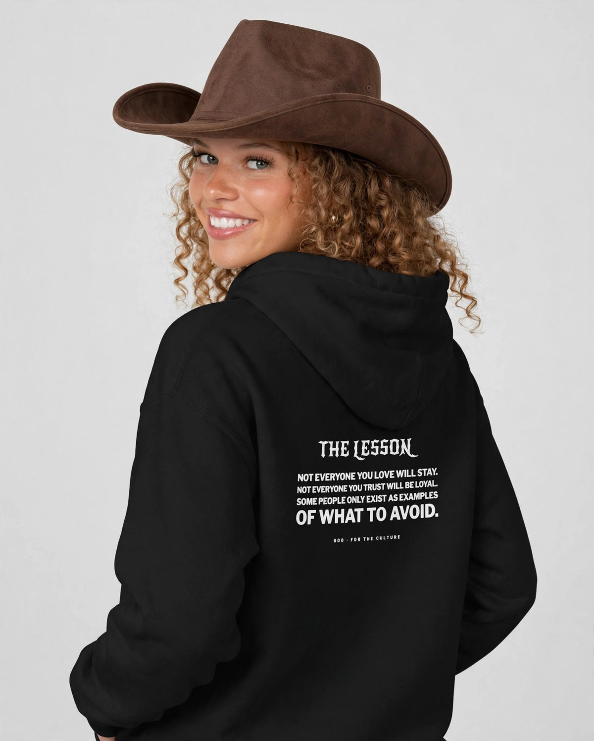 Amara wearing the The Lesson Hoodie – New Rocker (Black), back view