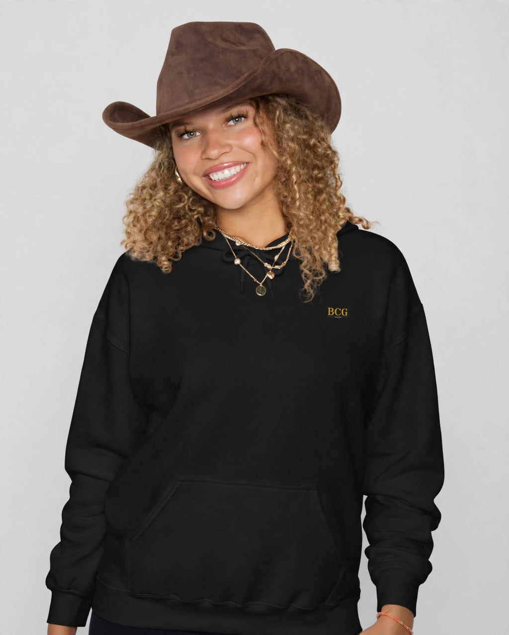 Amara wearing the Built Not Bought Hoodie – Trochut (Black), front view