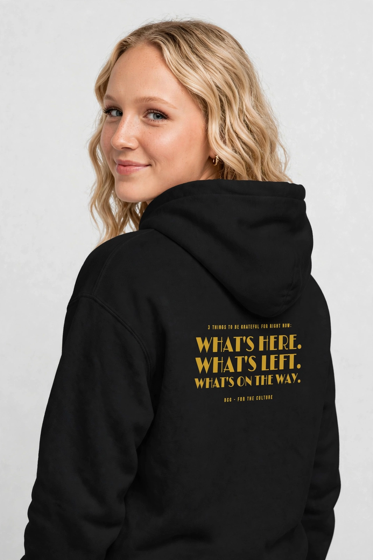 Harper wearing the Grateful Hoodie – Limelight (Black), back view