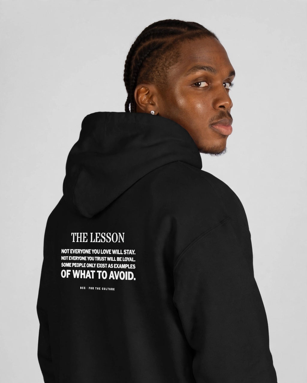 Patrick wearing the The Lesson Hoodie – Stencil (Black), back view