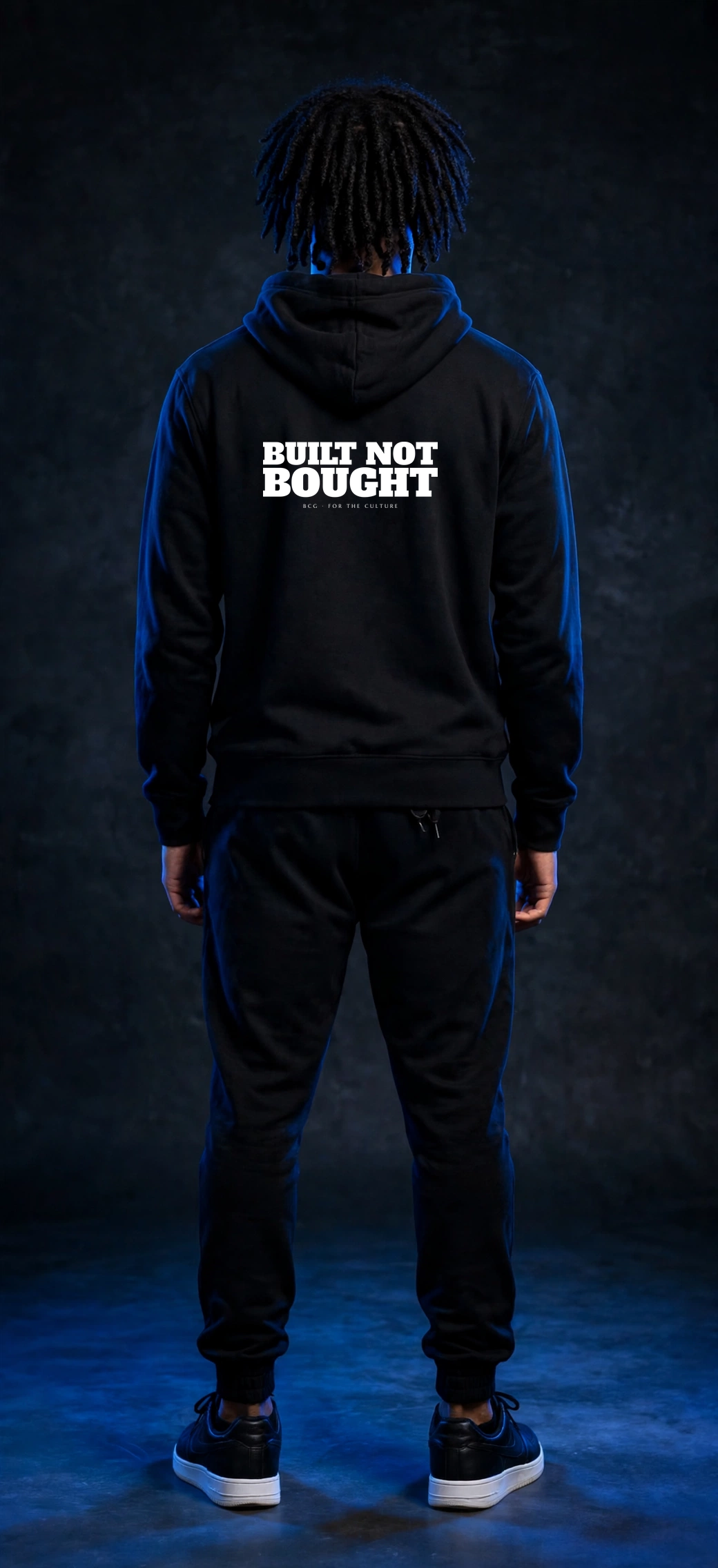 Sefi wearing the Built Not Bought Hoodie – Alfa Slab (Black) (back)